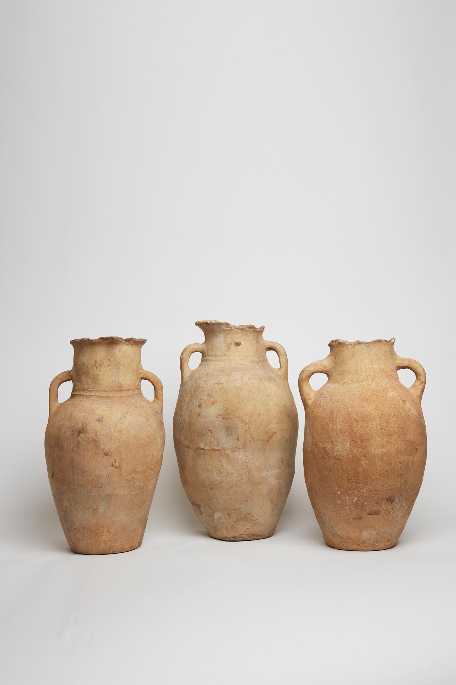 An imposing group of three superb terracotta jars with handles.
Near East, at least early 18th Century (most possibly earlier).
Vase 1: 56 cm high by 28 cm diameter.
Vase 2: 59 cm high by 29 cm diameter.
Vase 3: 52 cm high by 27 cm diameter.