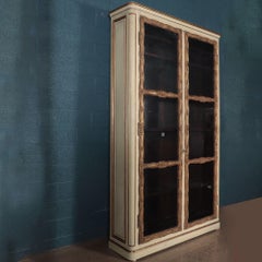 An imposing pair of cream painted and parcel gilt large bookcases, French, 19th