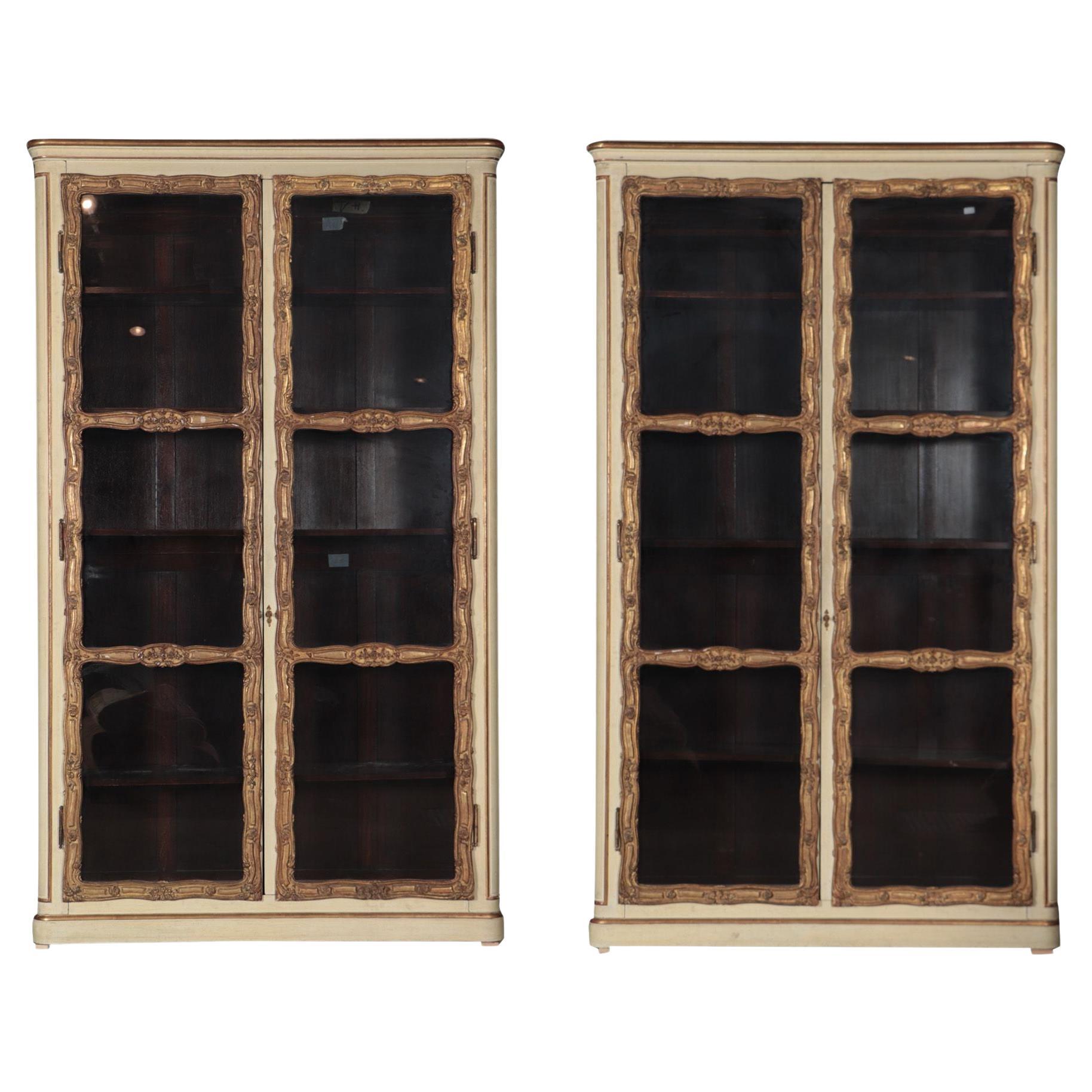 An imposing pair of cream painted and parcel gilt large bookcases, French, 19th  For Sale