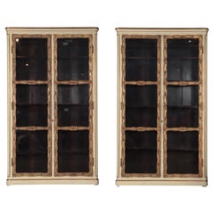 An imposing pair of cream painted and parcel gilt large bookcases, French, 19th 
