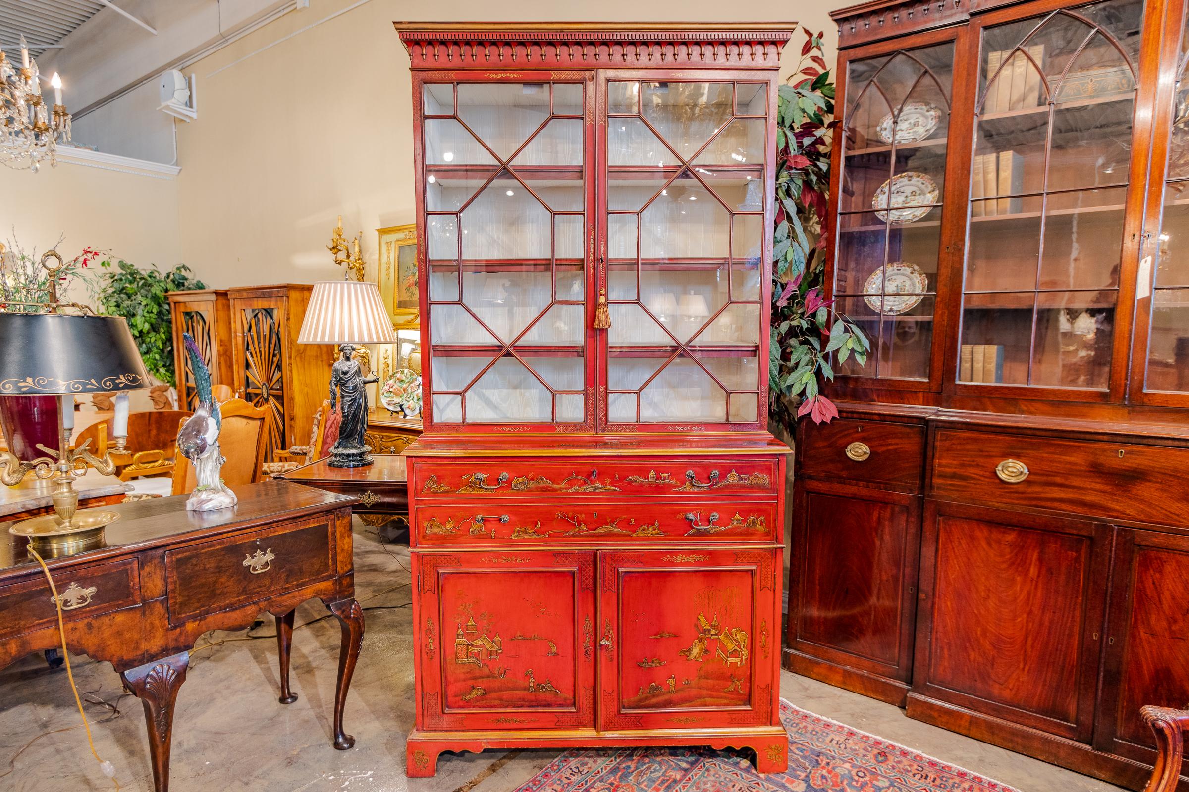 An impressive 18th century English chinoiserie red lacquered drop front secretary. Fine quality hand painted decoration Original glass doors. 
Leather writing surface.