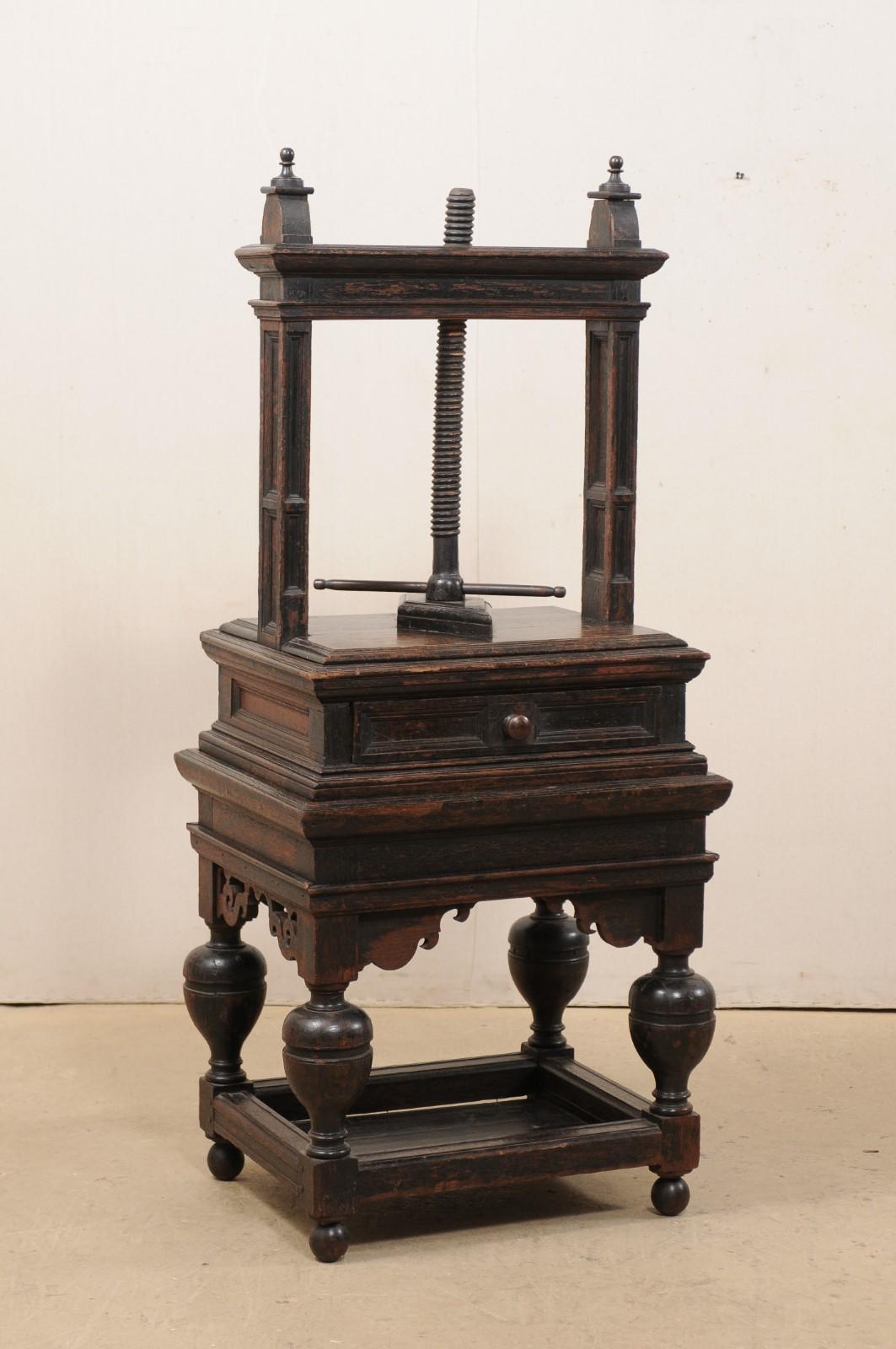 A Flemish freestanding book press from the 18th century, possibly older. This antique book press from Belgium is a fabulous piece of decorative art on its own. Standing approximately 5.5 feet in height, this oak wood piece is comprised of a