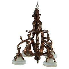 An impressive Arts and Crafts copper chandelier with original vaseline shades