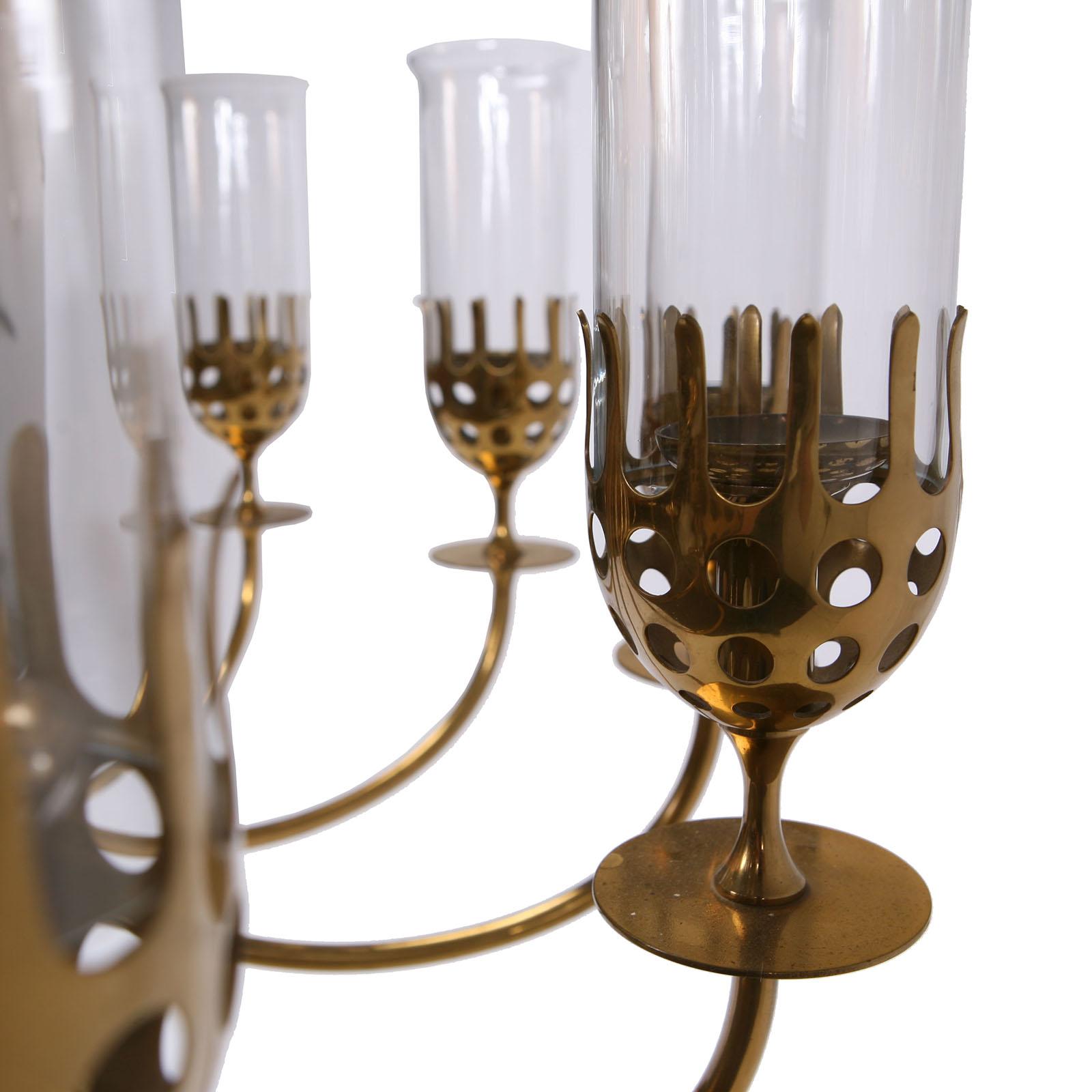 A large brass chandelier with twelve arms for candles.
Designed by Danish artist Bjørn Wiinblad, circa 1970.