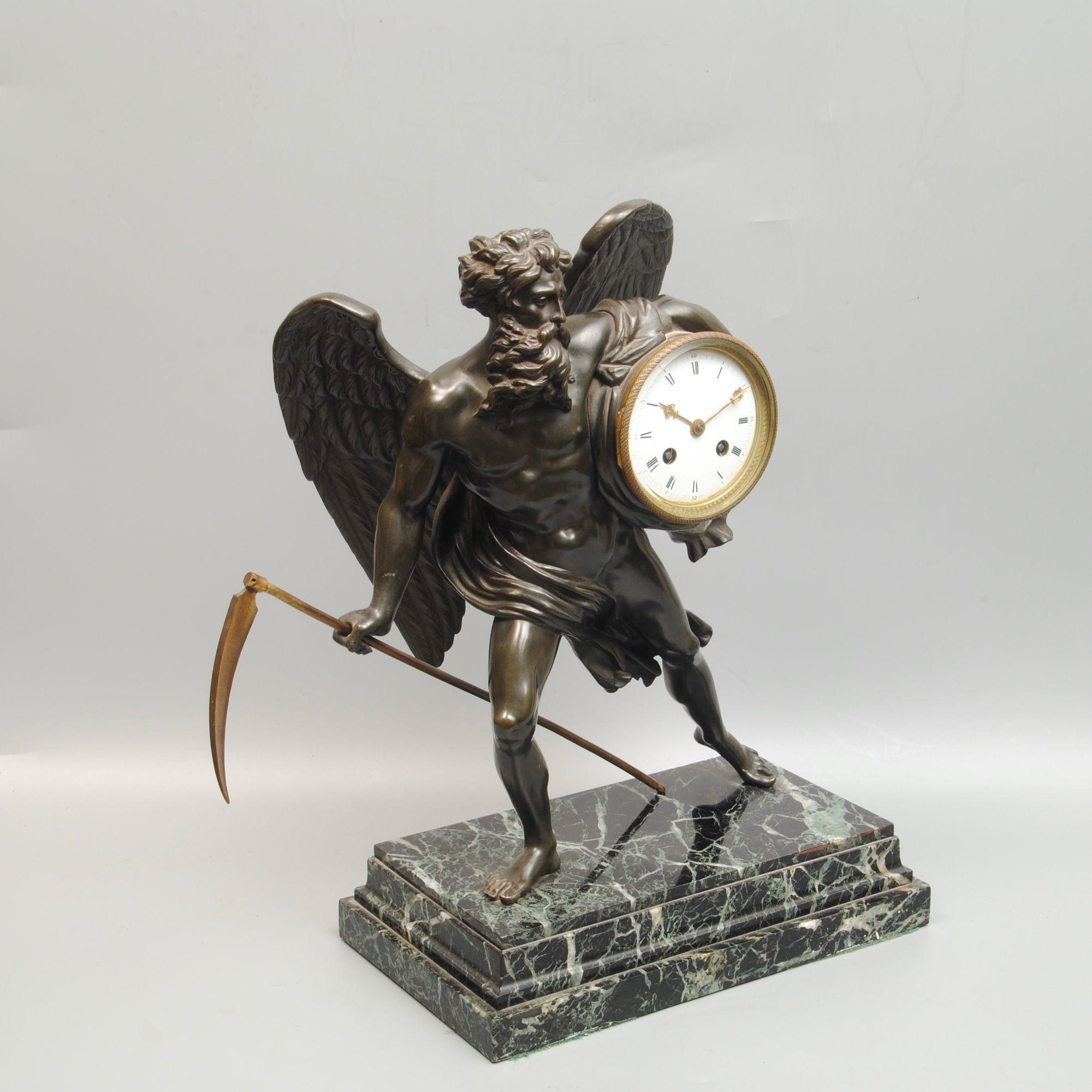 A large late 19th century French bronze of Chronos holding a clock under his arm raised on a marble plinth and with his scythe. The casting of the bronze is superb quality.
The two train platform escapement with the makers mark on the back has an