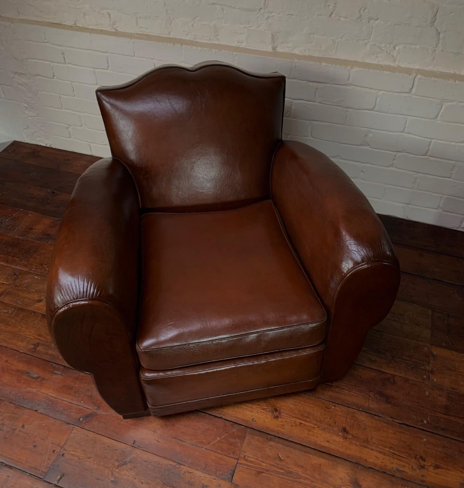 This beautiful and rare chair is a fantastic example, it is the classic of classics, in its original Havana brown leather, with Cuban cigar arms and a low-slung back; this chair has got the lot. The patina is gorgeous and testament to its first