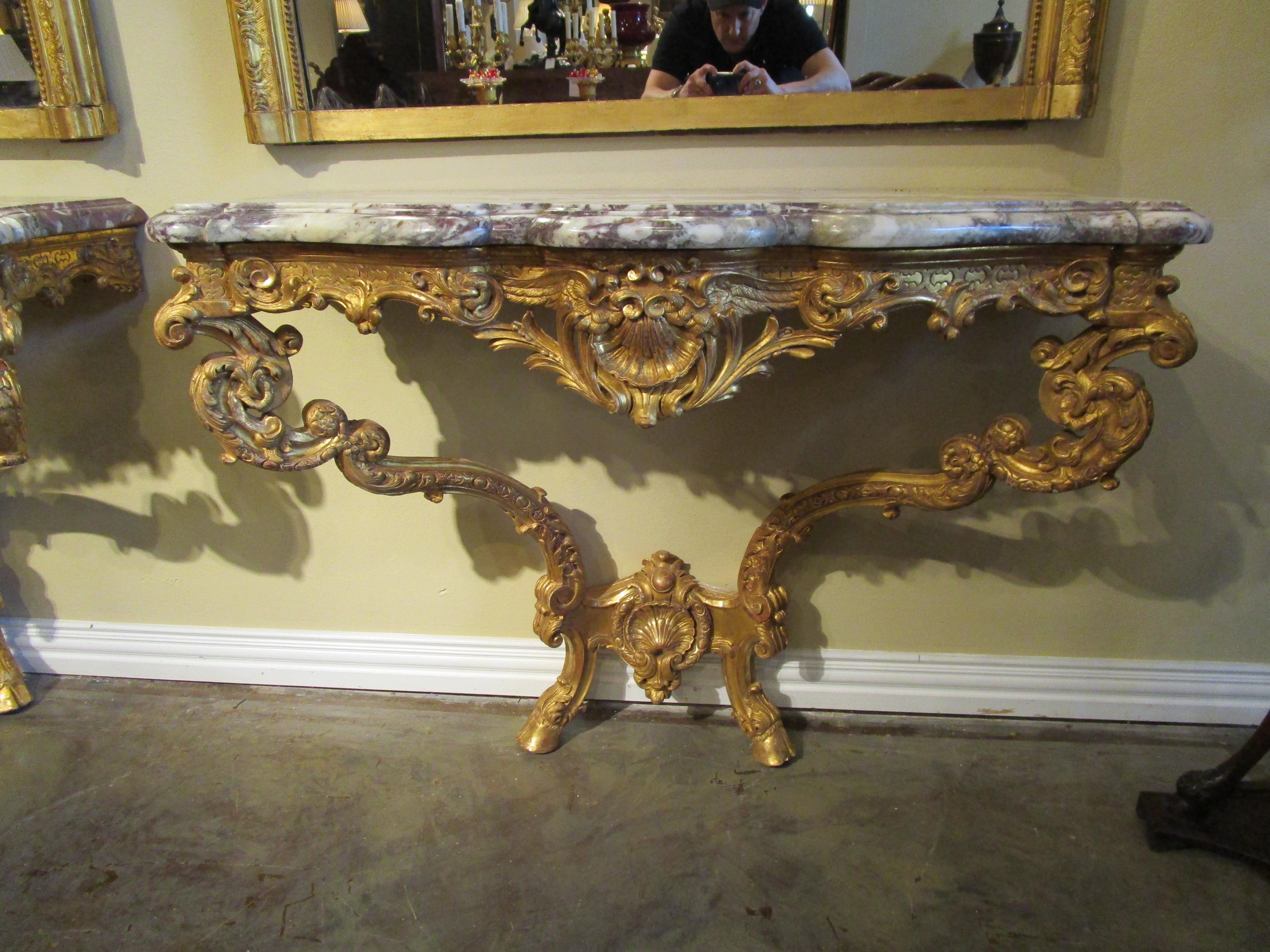 A very fine pair of early 19th century French Louis XV carved and gilt marble top consoles. Beautifully carved and original gilt. Breche Violette original marble tops.