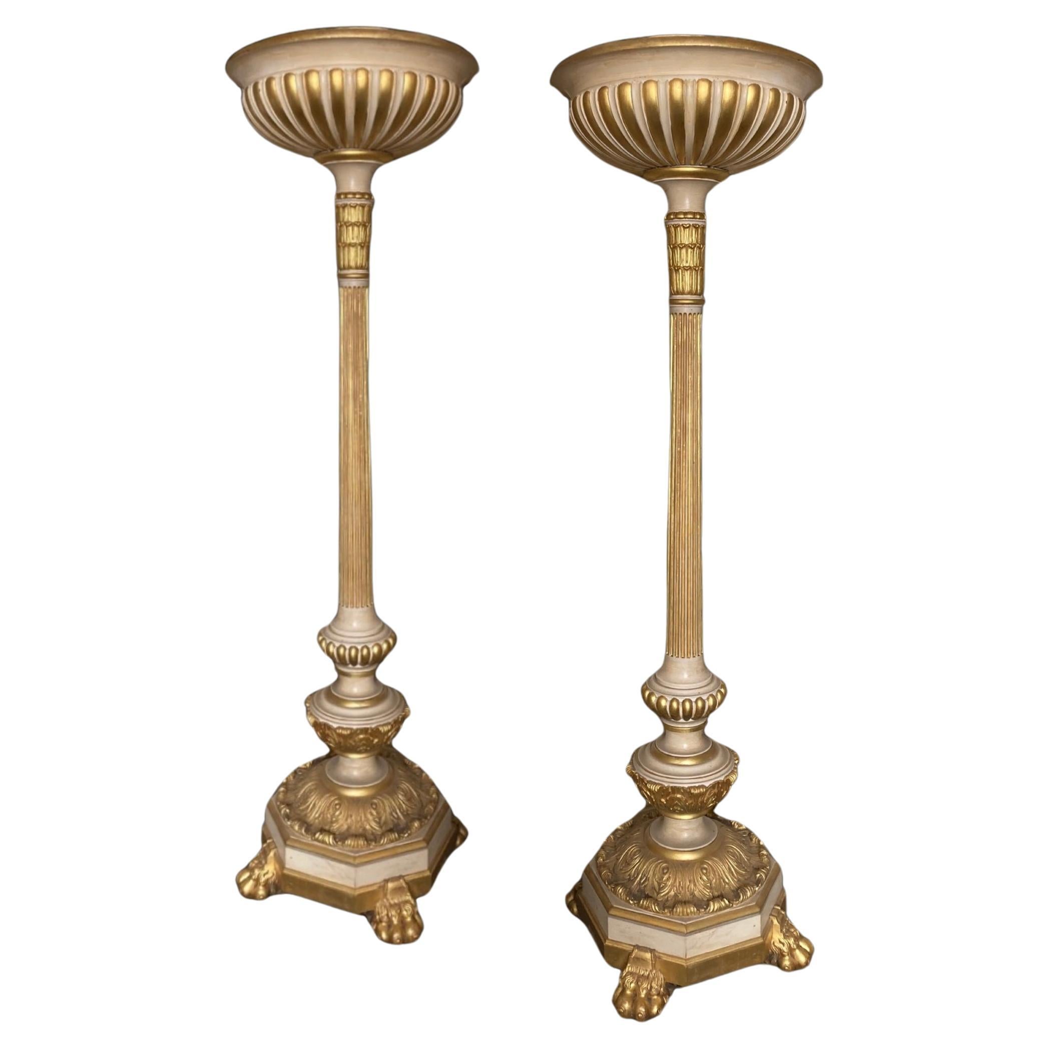 An impressive pair of gilt and painted uplighters For Sale