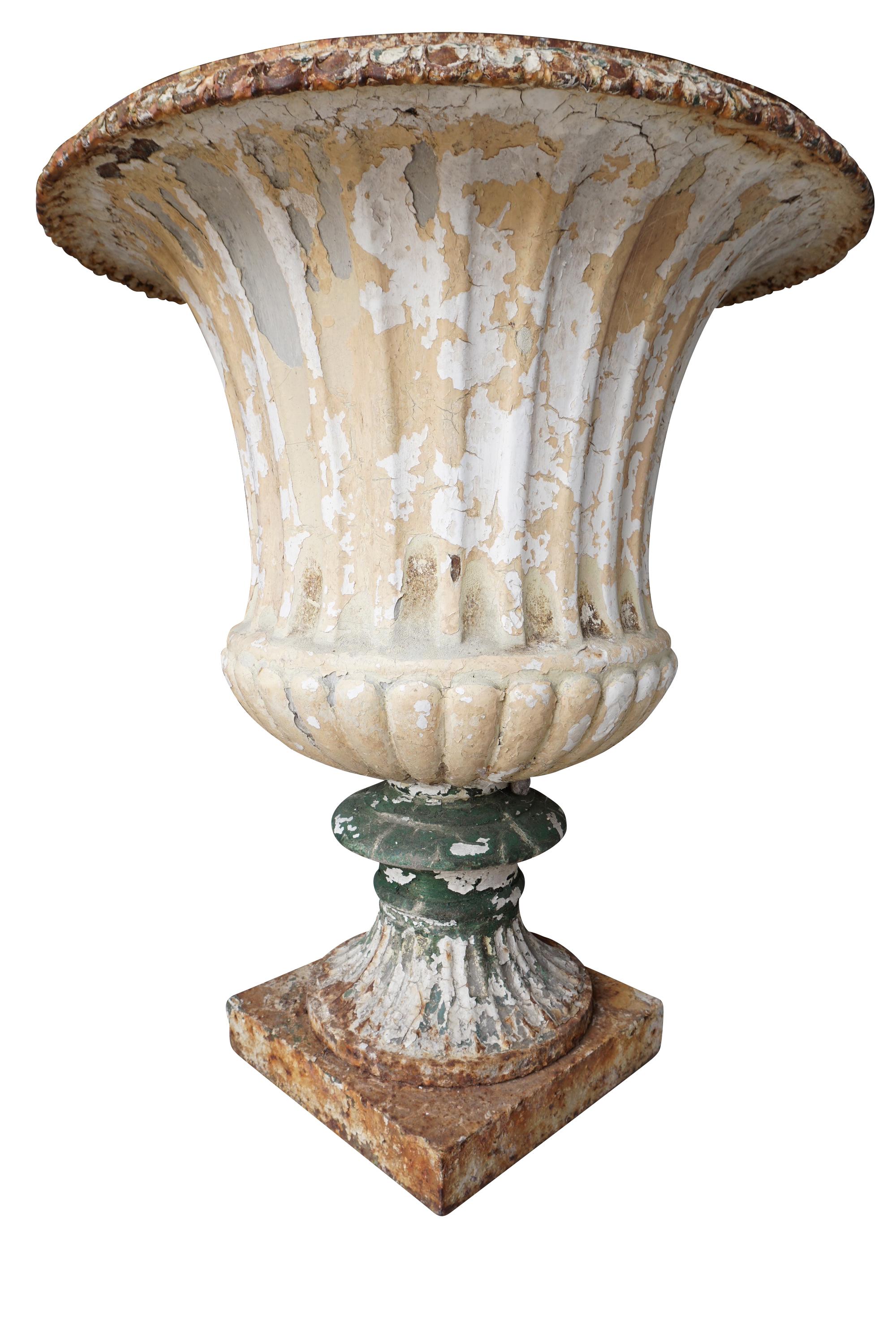 An impressive pair of Handyside cast iron garden urns with fluting, on turned socle and square plinth base

Andrew Handyside bought the Britannia Iron Works in 1848, they were renowned for the quality of their castings and were commissioned to