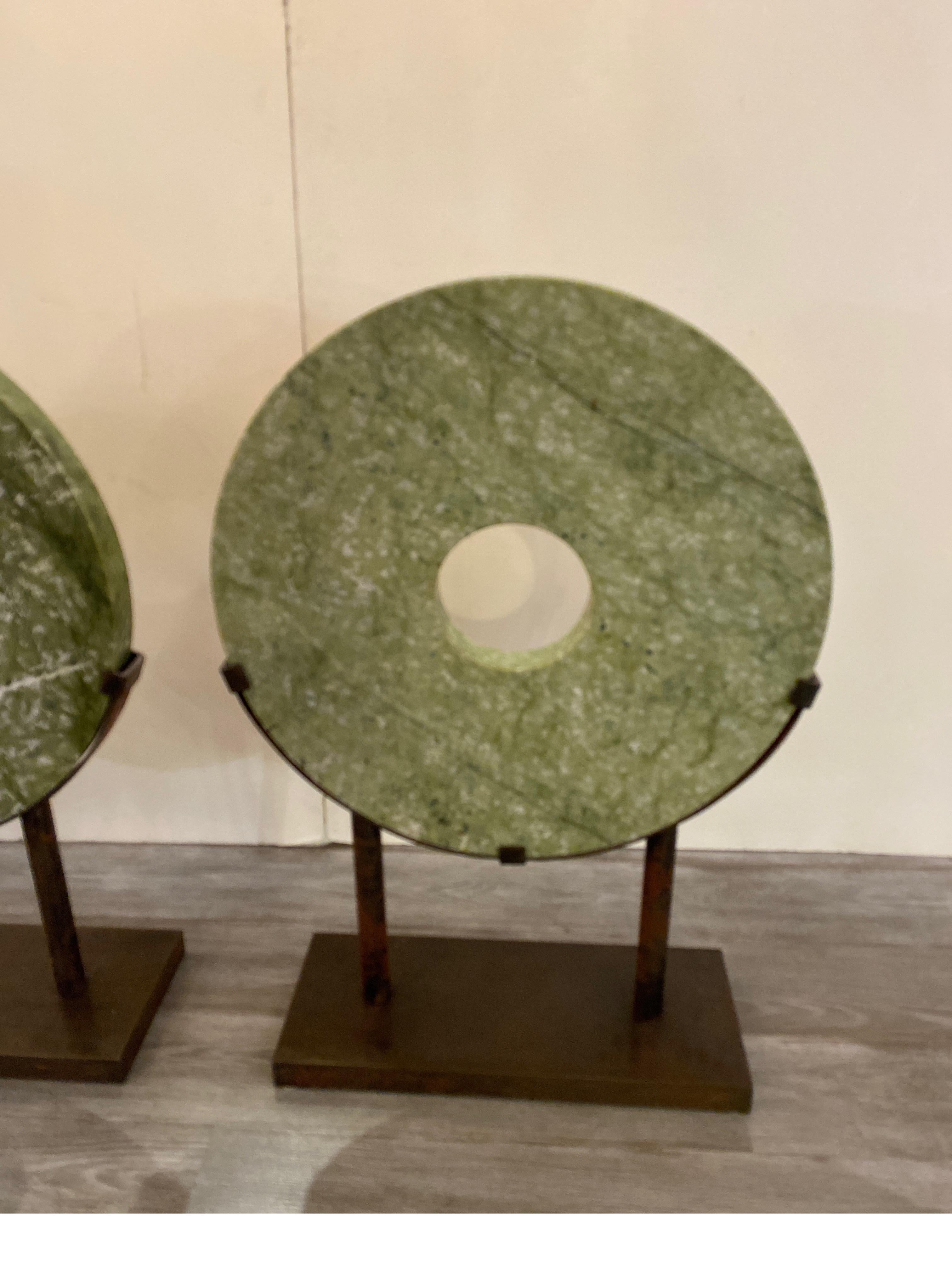 A pair of large round hardstone or marble Chinese sculptures with custom aged steel bases. the stone circles are 24 dimeter and 1.05 inches deep, total measurement is 34.5 high, 24 wide 8 deep with the steel stands. These are solid and heavy and