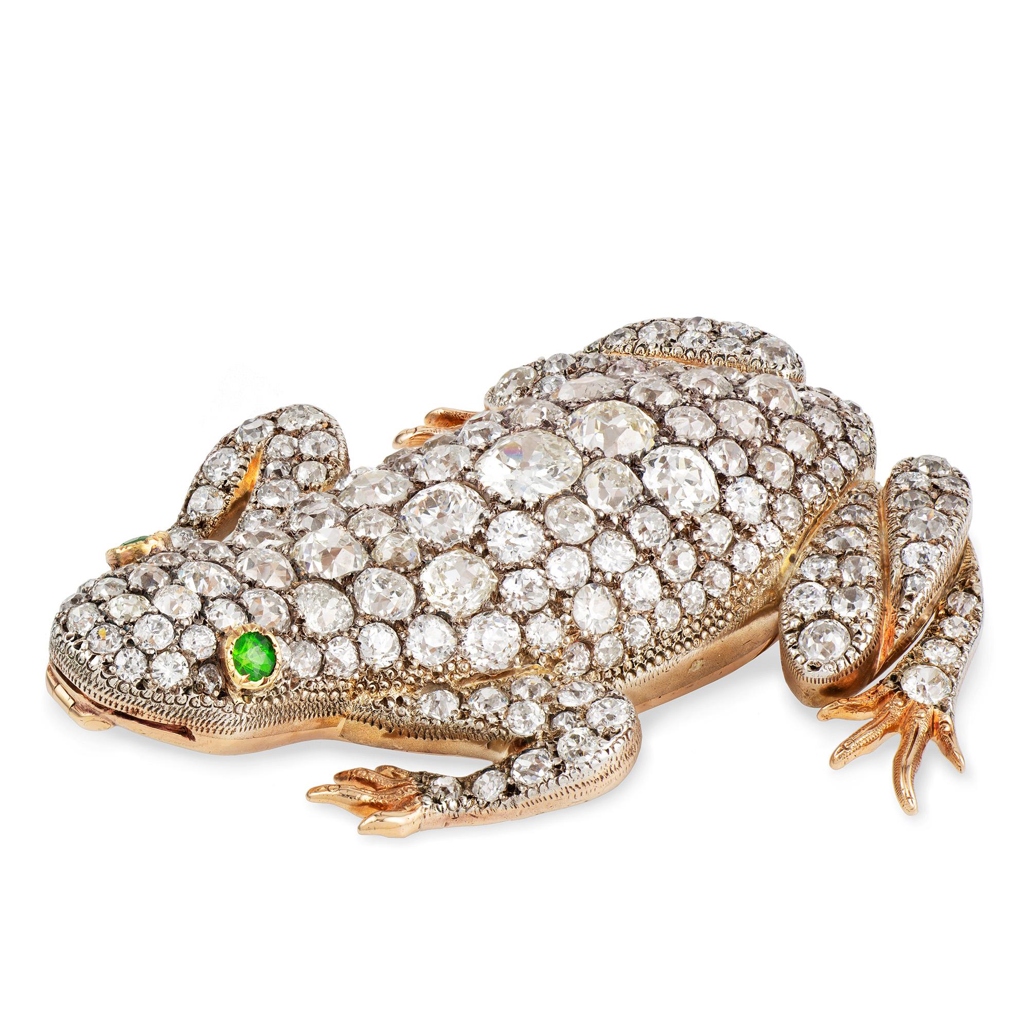 An impressive Victorian diamond-set frog, the realistically carved body set with old European-cut diamonds estimated to weigh a total of 24 carats, and faceted demantoid garnet-set eyes, all mounted in silver on red-gold back, with gold brooch and