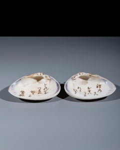 An incense box in the shape of a shell with waka inscriptions