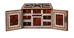 An Indian colonial tortoiseshell veneered teak portable two-door cabinet