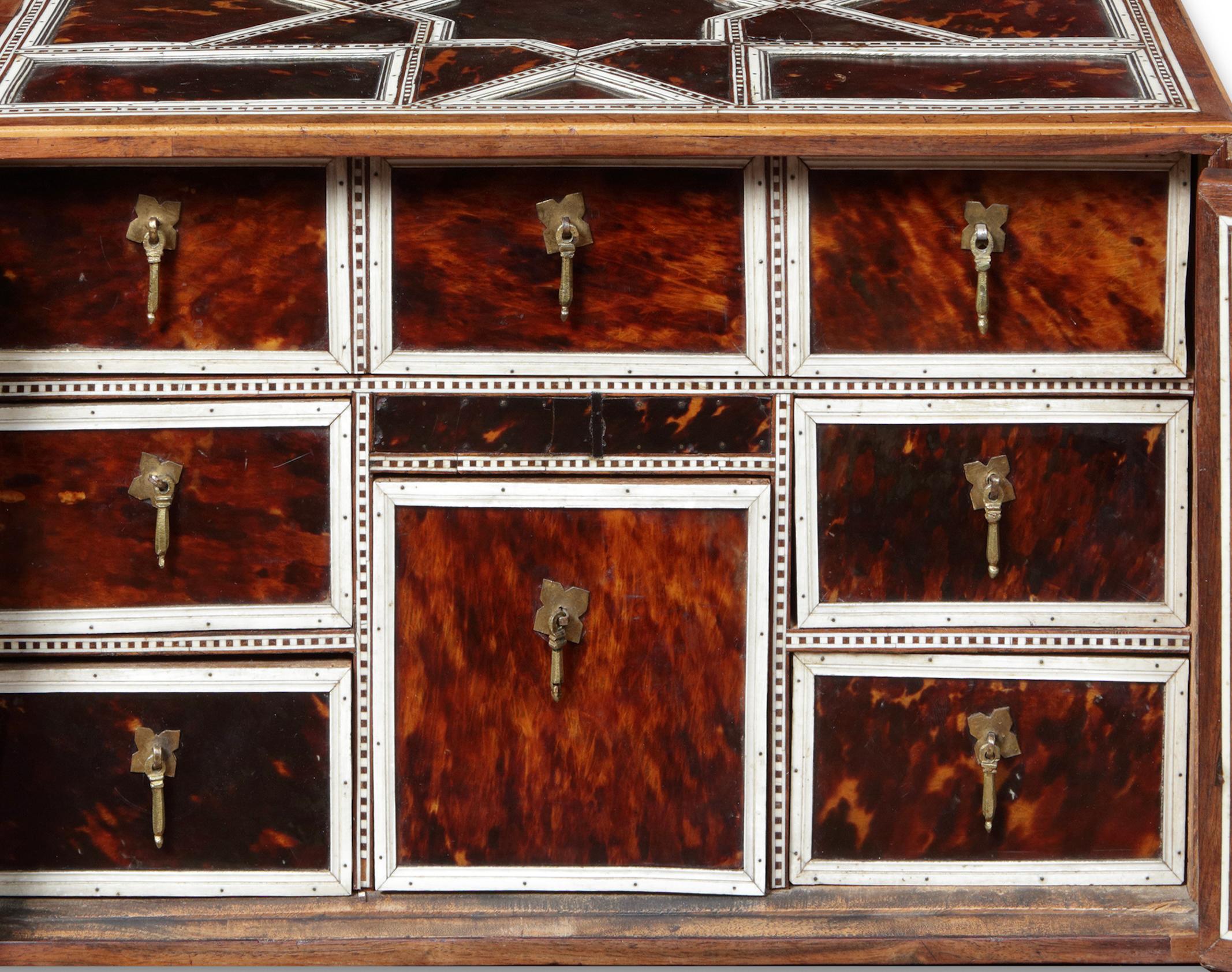 Veneer An Indian colonial tortoiseshell veneered teak portable two-door cabinet For Sale