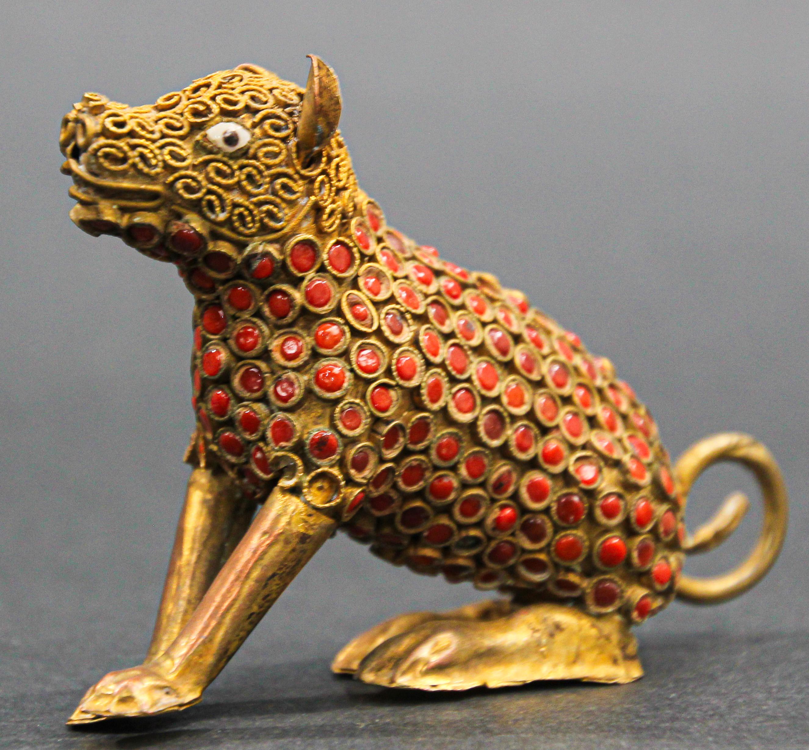 Vintage Indian Mughal style metal brass and red stone inset dog figure. 
In the style of Mughal Indian jewelry collectible small model of a seating dog with red inset stones.