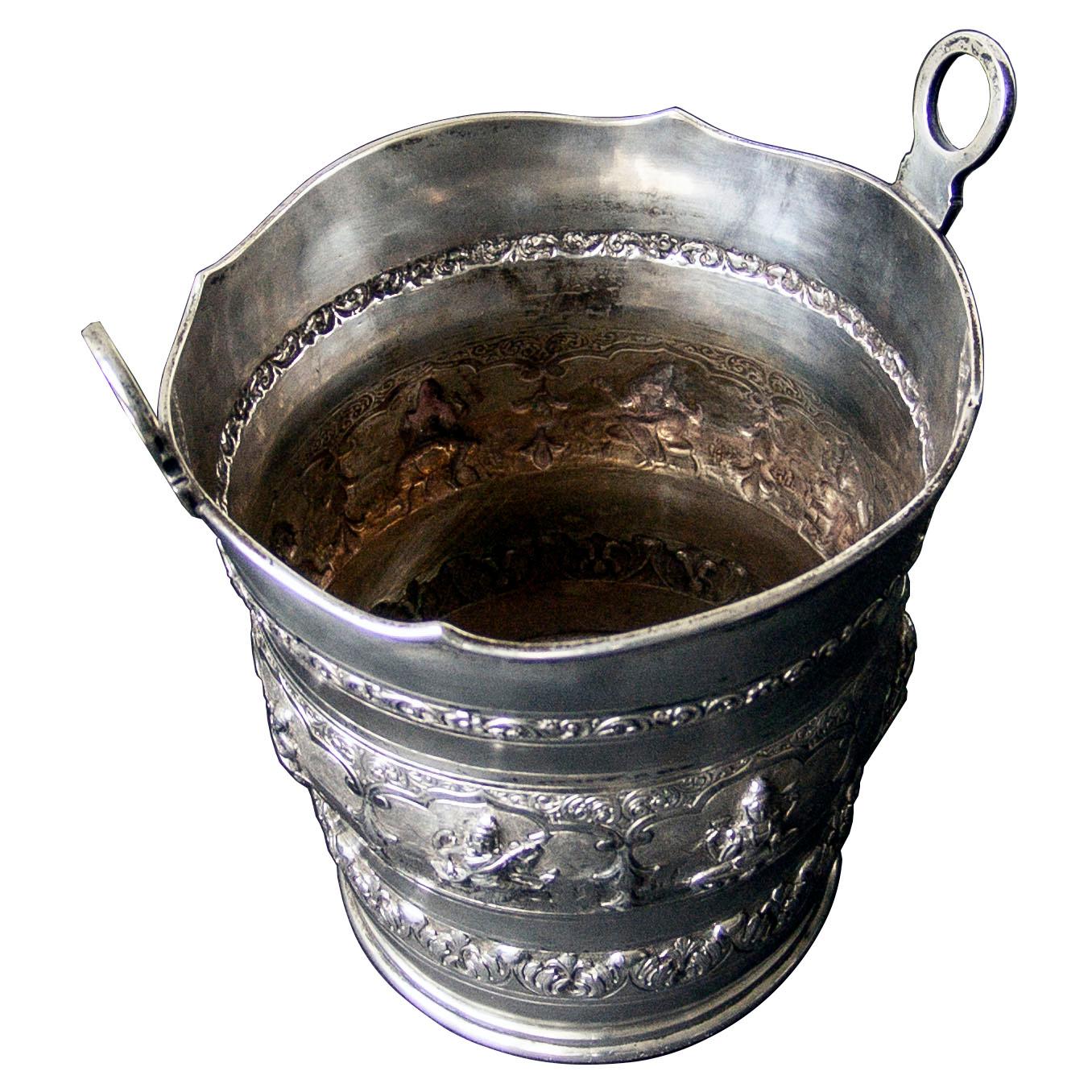 A superb quality Indian silver ice pail with circular base and flared design with shaped threaded rim supporting two ring handles. The body decorated with chased figural and floral design 