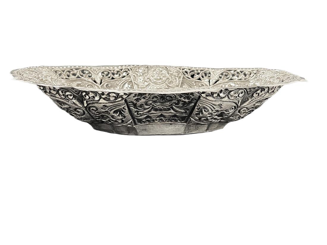 Indonesian Yogya, Djokja Openwork Basket, Late 19th Century

An openwork basket with elegant 8-sided scalloped edges, with four Kala heads, between a floral pattern and centered on the bottom 2 snakes, intertwined.
The silver from the former Dutch