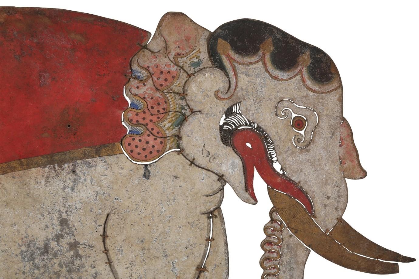 An Indonesian Wayang Kulit Shadow Puppet of Gajah (Elephant), Java, Indonesia, South East Asia, late 19th – early 20th century

Opaque pigments heightened in gold on hide, designed in the shape of a large grey elephant with golden tusks and bulging