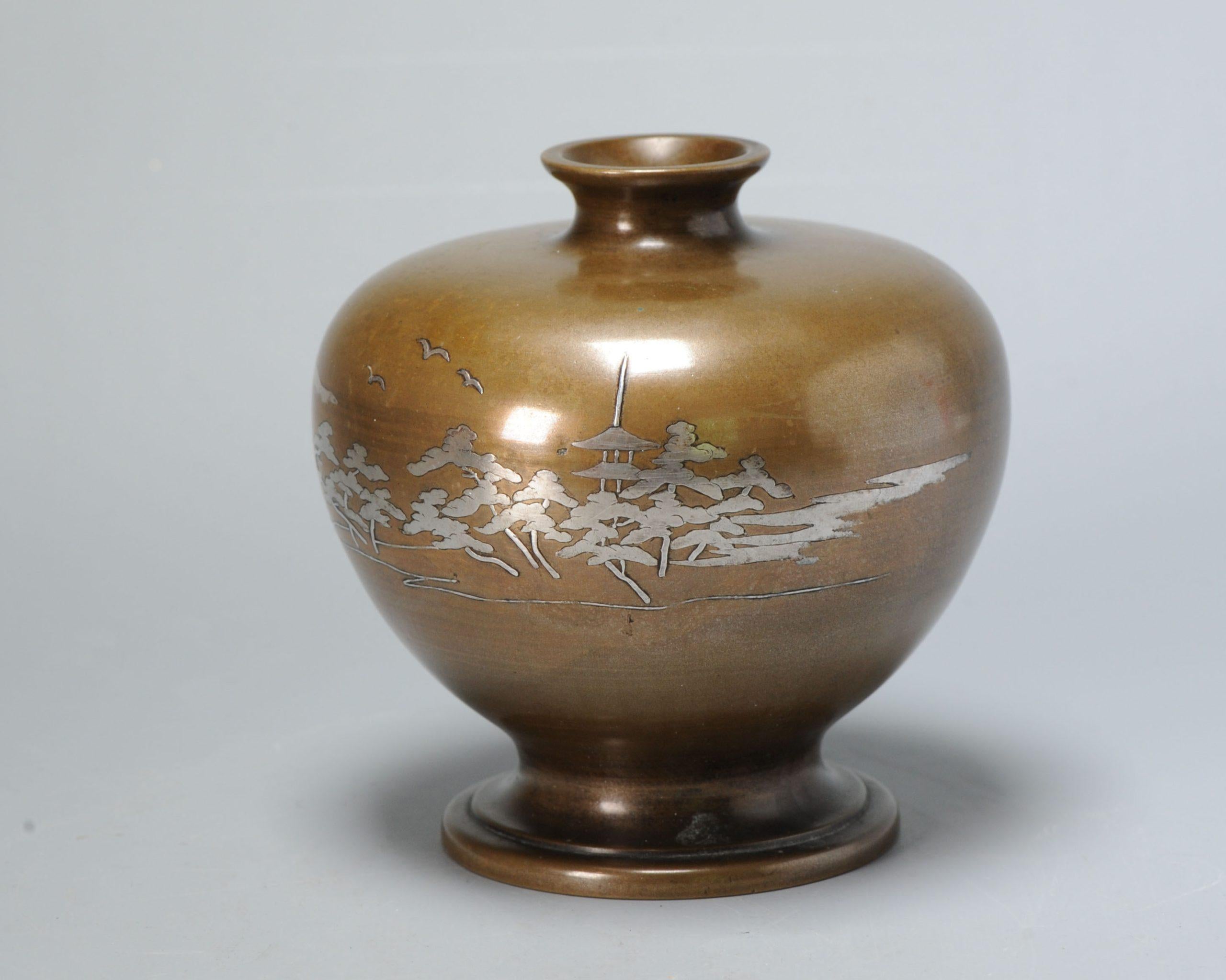 Japan, silver inlaid bronze vase, Meiji period (1868-1912), the bulbous vase inlaid with a temple in a landscape,

28-6-22-1-12

Condition
no real damages found, just a small process flaw in base and some ware. Size 130x120mm Height x