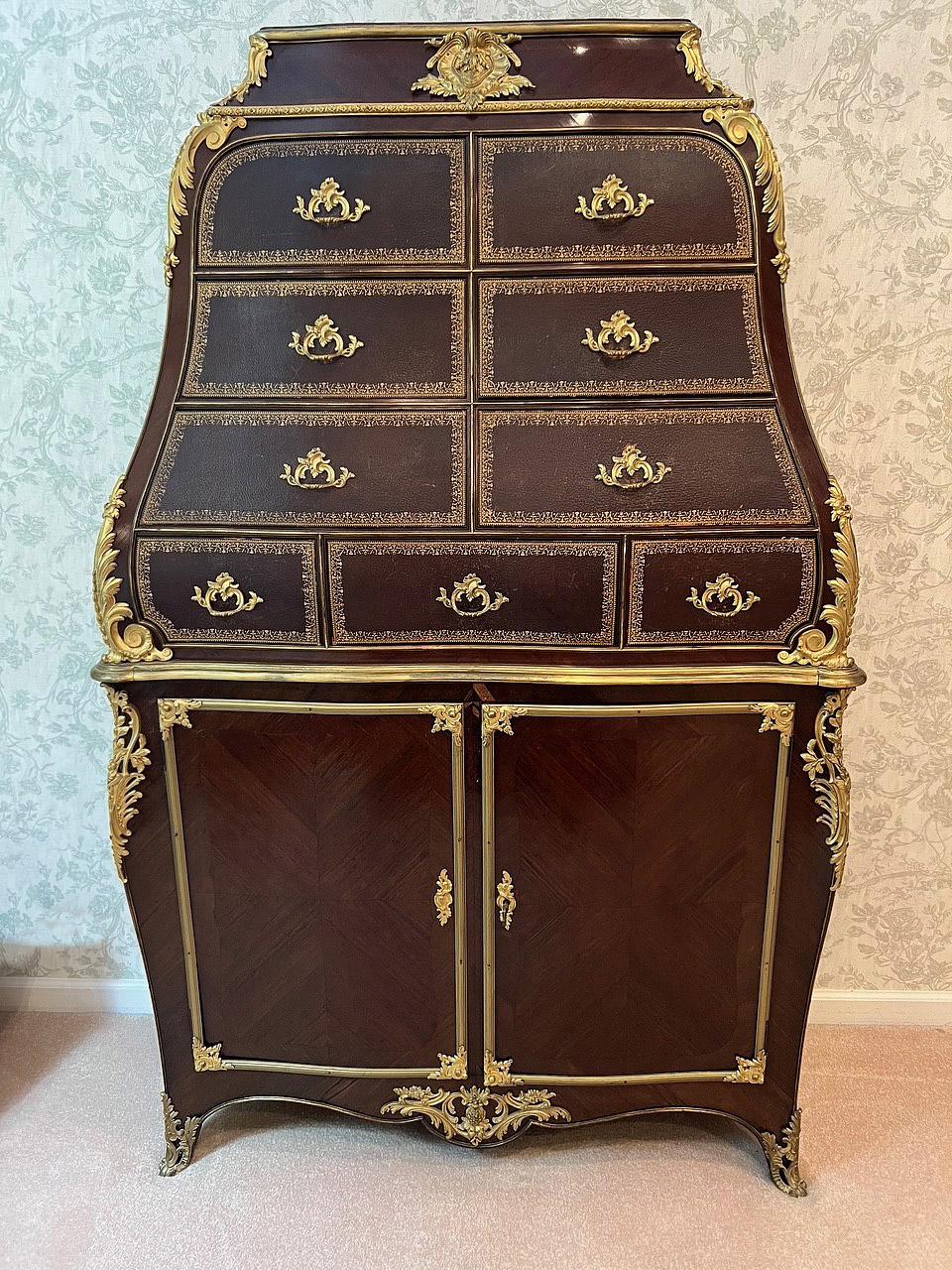 An Interesting Late 19th Century Gilt Bronze Mounted Cartonnier / Dresser

The tall cabinet with an upper section containing nine deep tooled leather veneer drawers, above two long doors opening an adjustable wooden shelf, the corners adorned with