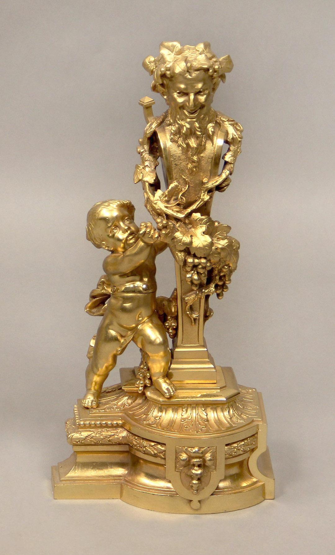 An interesting pair of late 19th century gilt bronze chenets

Each depicting Bacchus, wrapped in grape vines, flanked by a cherub and standing on a bronze base.