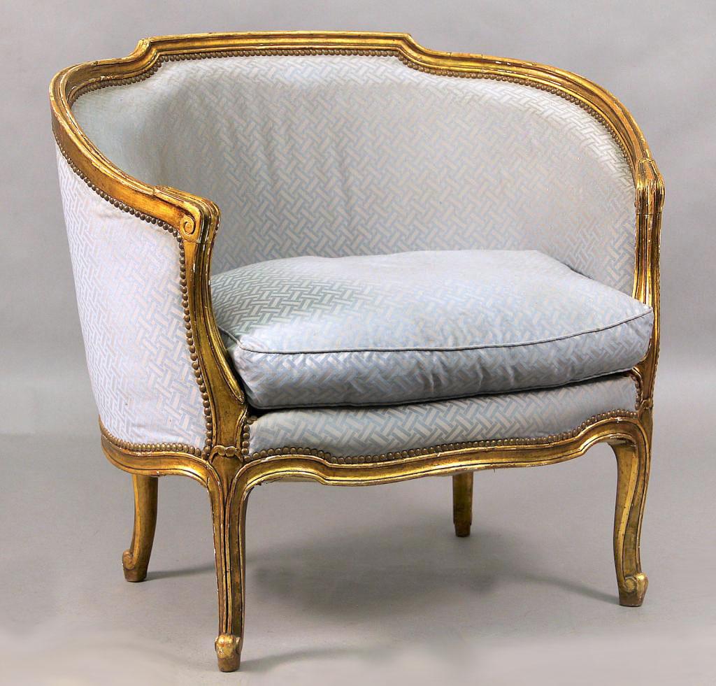 An Interesting pair of late 19th century Louis XV style giltwood bergeres.

With hand carved wide frames.