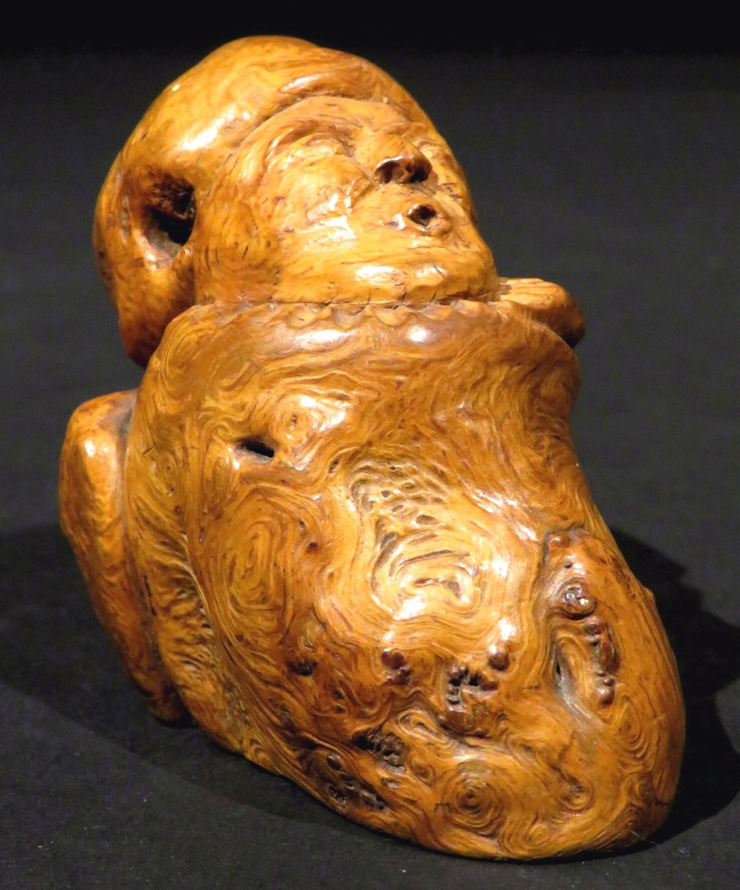 A most fascinating and intriguing hand carved objet d'art of a treen figure in burl wood, exhibiting wonderful form, grain, colour and patina. The underside bearing remnants of an old paper label with hand written script together with the numerals