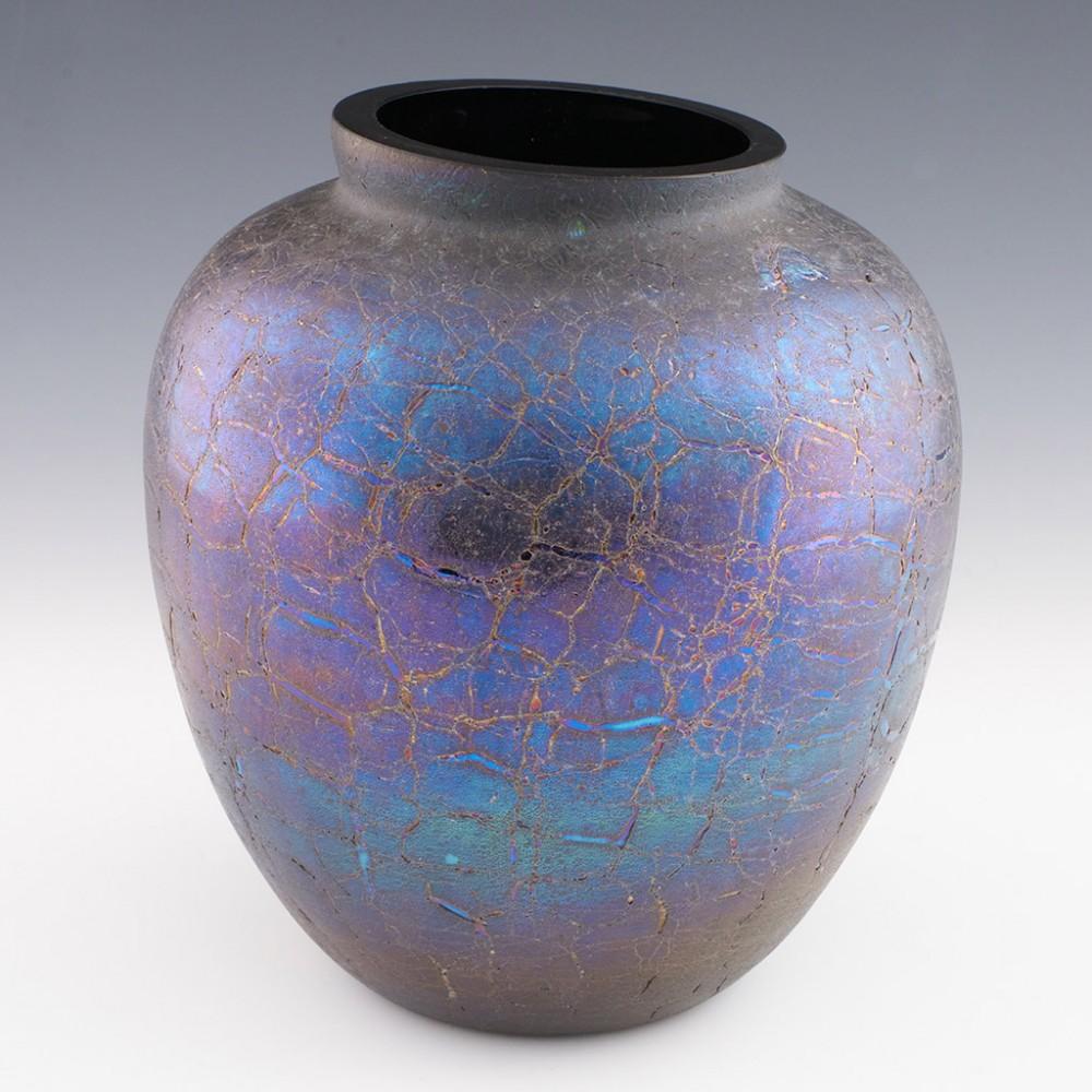 Heading : An Iridescent Kralik Crackle Glass Vase
Date : c1905
Origin : Bohemia
Bowl Features : An ink blue ground with iridescent indigo and blue sale finish with aventurine effect
Marks : None
Size : Height 20.4cm, width 18.5
Condition :