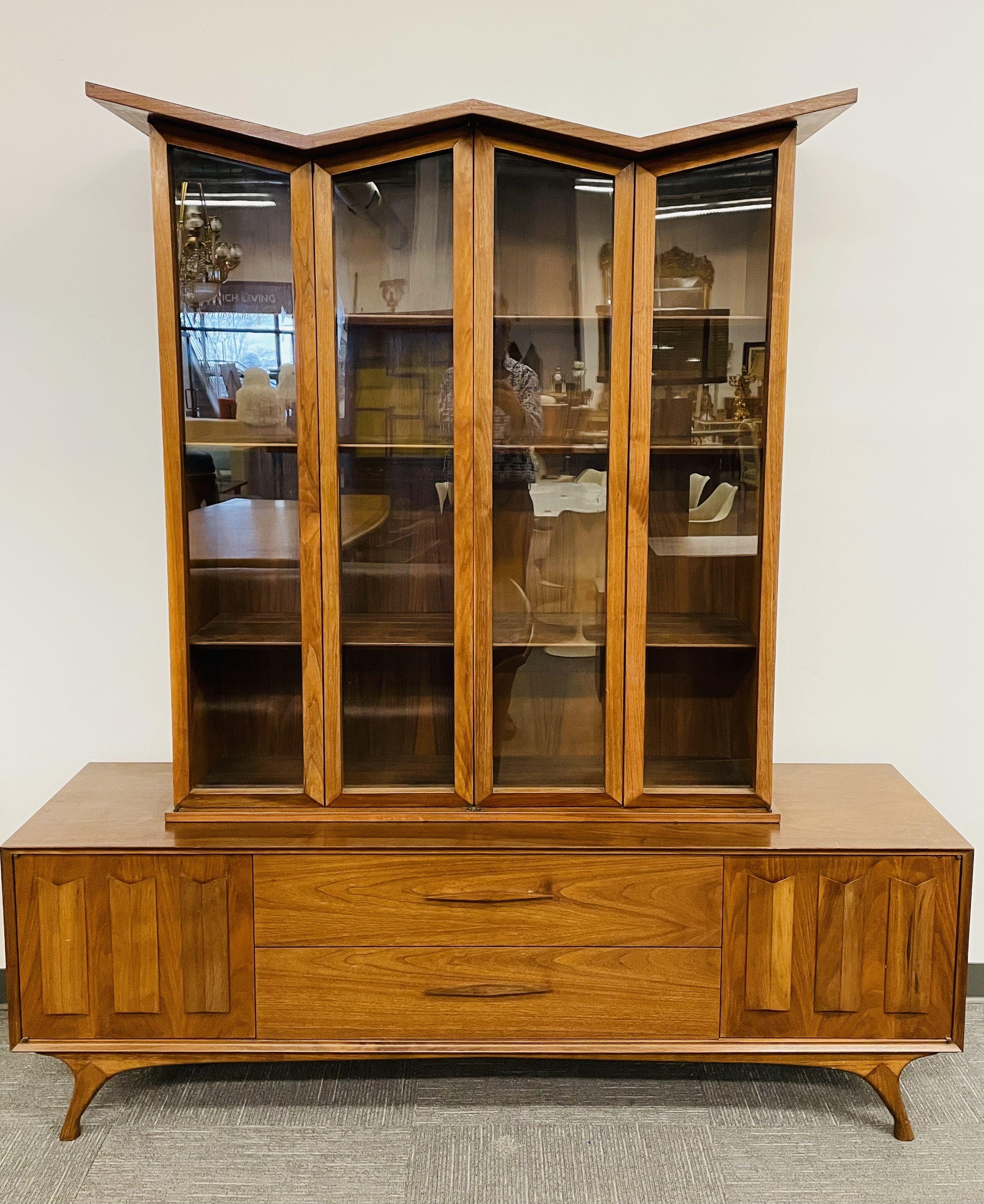 A Fine Mid-Century Modern breakfront of showcase cabinet having four glass doors with six adjustable shelves. This two piece stunning China or Display Cabinet bears the Irish Handcut label sitting on a sideboard base of geometric form having two