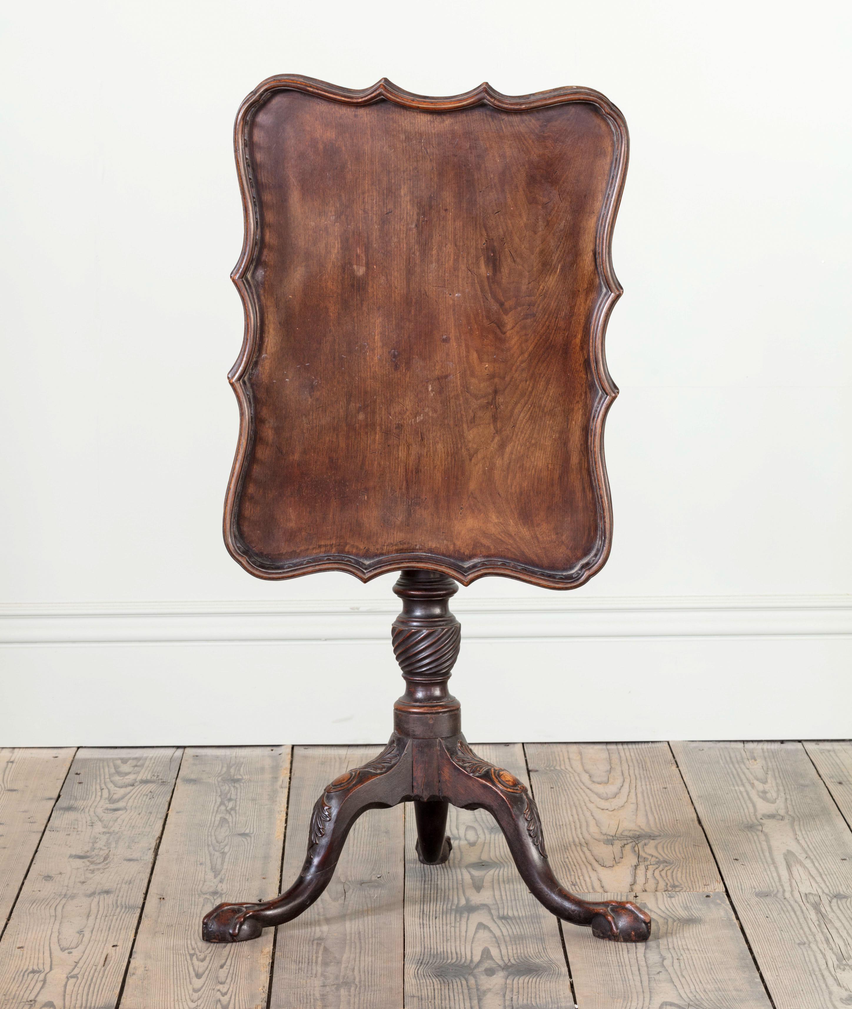 A rare 18th Century tripod table, resting on an acanthus carved base, with ball and claw feet.

Irish, c.1760