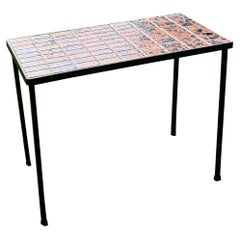 An iron and ceramic end table