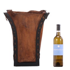 An Iron and Leather Waste Basket.