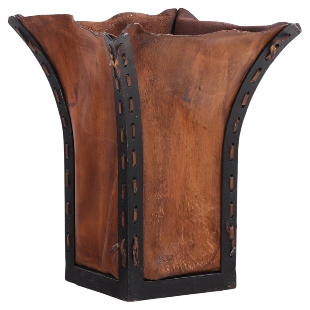 An Iron and Leather Waste Basket.