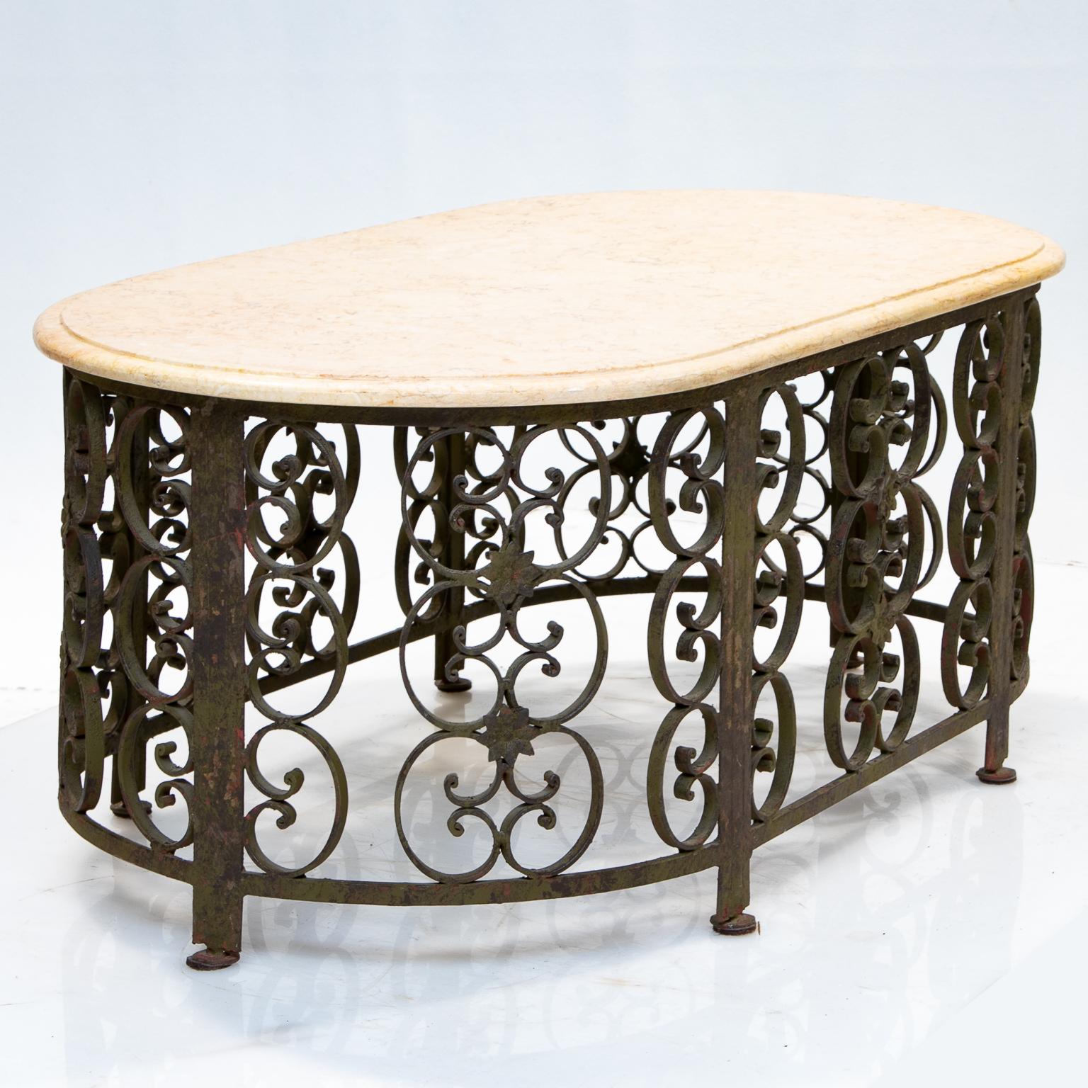 An iron and marble-top coffee table

This is an oval ended scrolled iron base with a rustic finish and having a marble top (Hauteville style). This is from an estate and unsure of history, but very nice quality and forging.