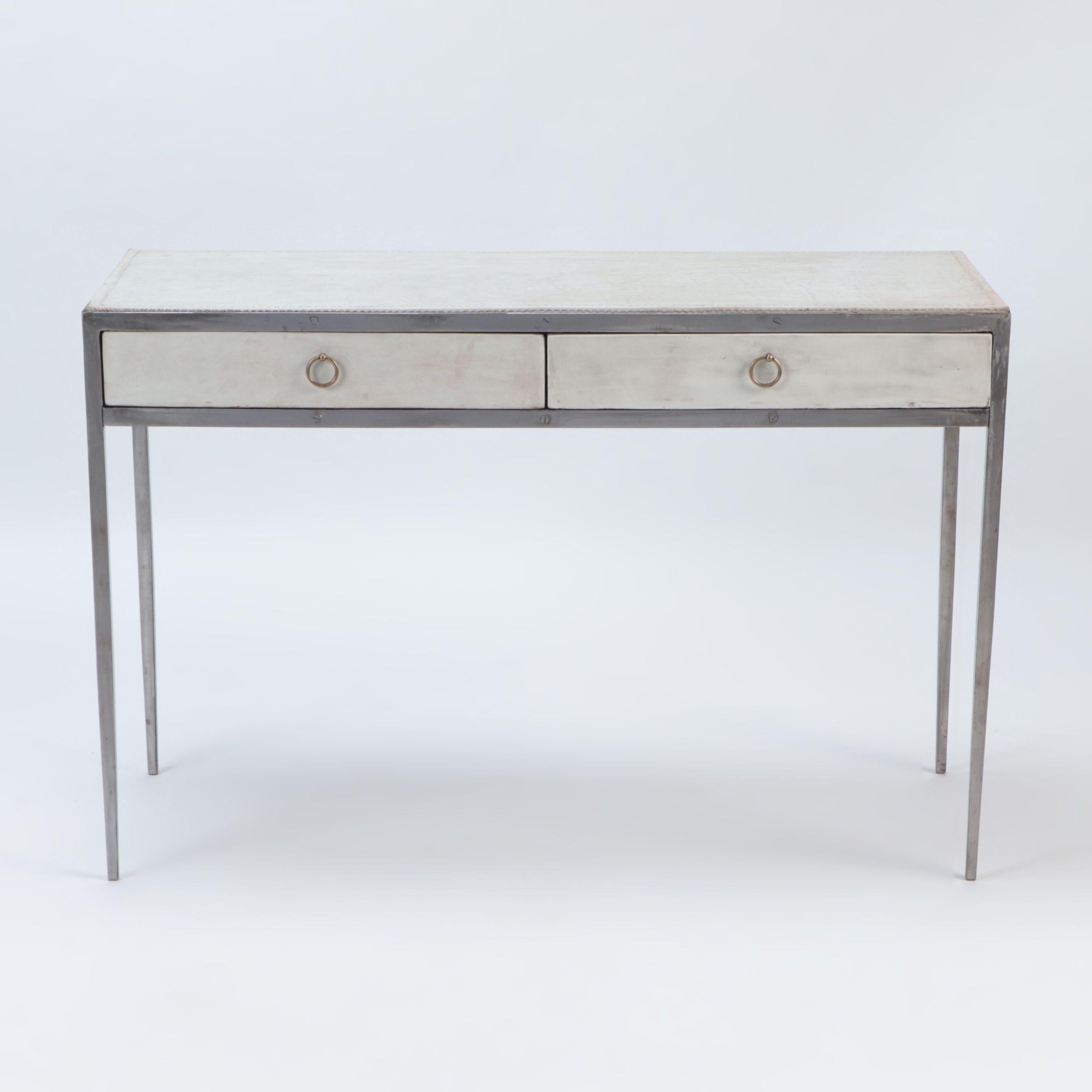An iron and parchemnt desk in the manner of Jean-Michel Frank, contemporary.