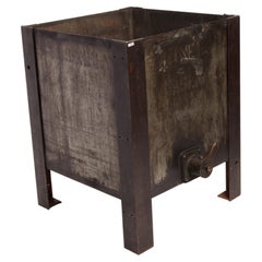 An iron industrial oil container, reused as flower box, United States early 1900