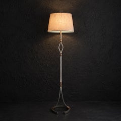 An iron & leather floor lamp by Jean Pierre Ryckeart