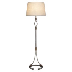 An iron & leather floor lamp by Jean Pierre Ryckeart