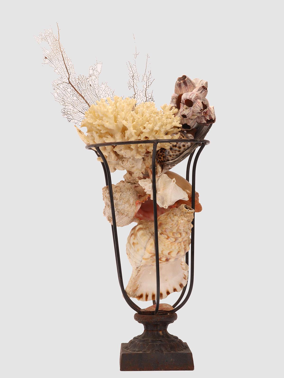French An iron vase full of shells, France circa 1890. For Sale