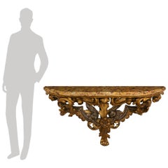 An Italian 18th century Giltwood, Mecca, and marble wall bracket/console