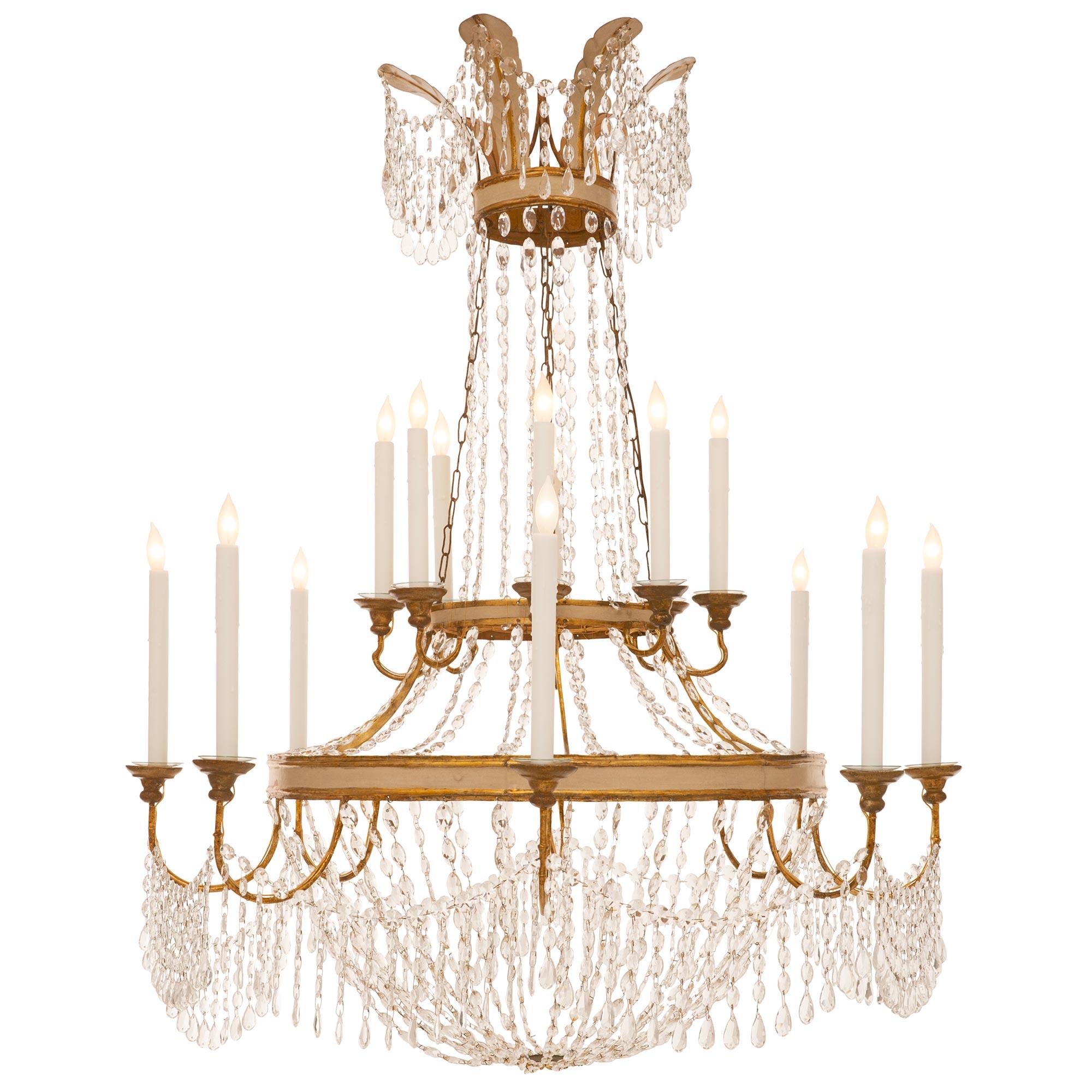 An elegant Italian 18th century Neo-Classical st. patinated off white, Mecca and Iron chandelier. The two tiered sixteen arm chandelier has a montgolfière shape. The lower patinated off white and Mecca finished metal band supports the scrolled arms