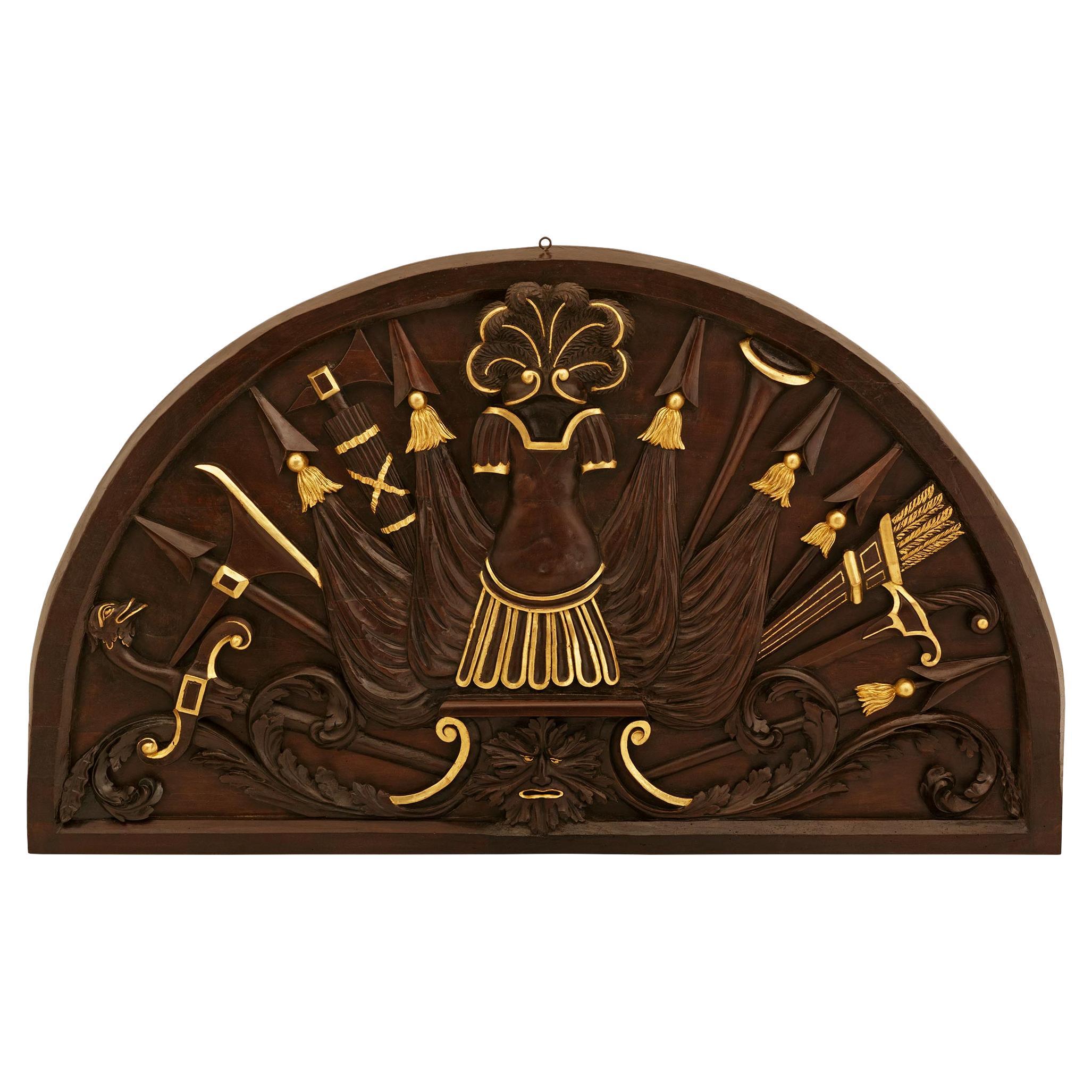 An Italian 18th century Neo-Classical st. patinated Wood and Giltwood plaque.