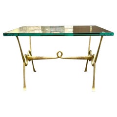 An Italian 1950s brass and thick glass cocktail table by Janetti, Florence
