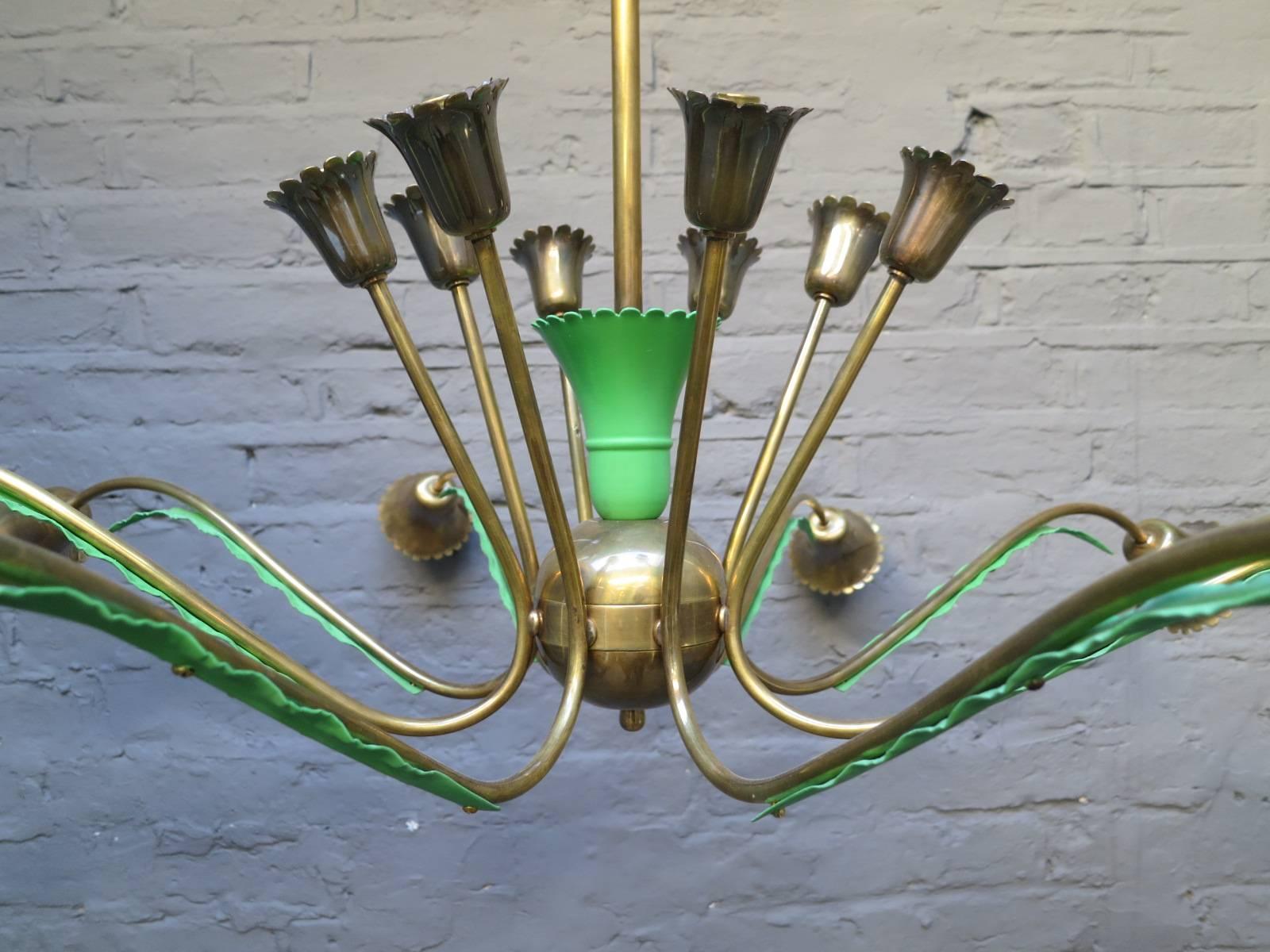 A large sixteen-arm chandelier in brass with lacquered green accents, bulb holders and ceiling rose. Re wired and restored to an exacting standard.