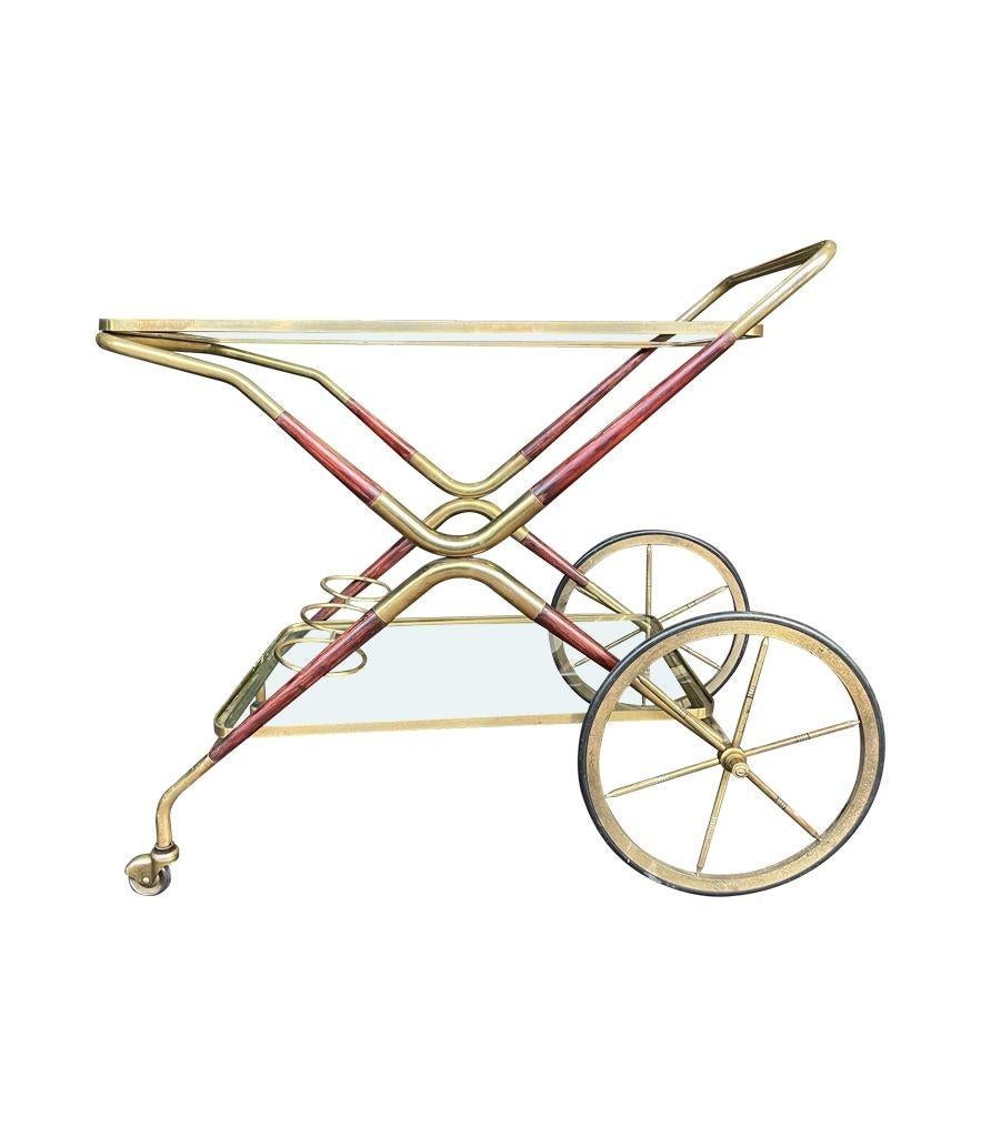 An Italian 1950s Cesare Lacca wood and brass bar cart trolley with brass drinks holder.