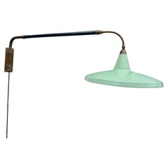 An Italian 1950s Stilnovo brass telescopic wall light with stitched leather arm