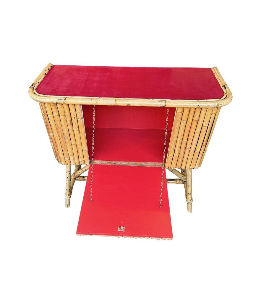 Bamboo An Italian 1960s bamboo bar cabinet with red laminate top and two stools For Sale