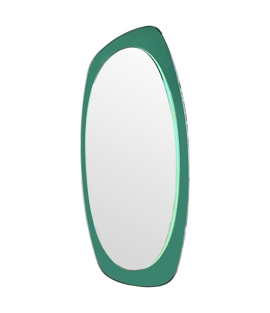 An Italian 1960s Cristal Arte oval mirror with pastel mint green mirrored frame. The mirror can be hung landscape or portrait and is in good overall condition.