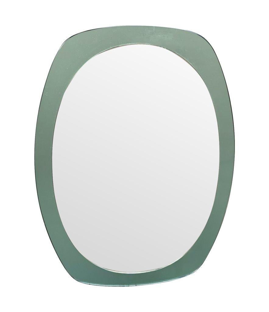 An Italian 1960s Cristal Arte oval mirror with mint green mirrored frame In Good Condition For Sale In London, GB