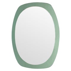 An Italian 1960s Cristal Arte oval mirror with mint green mirrored frame